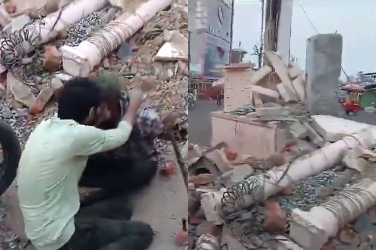 two drunkards crying after seeing broken statue of Mahatma Gandhi