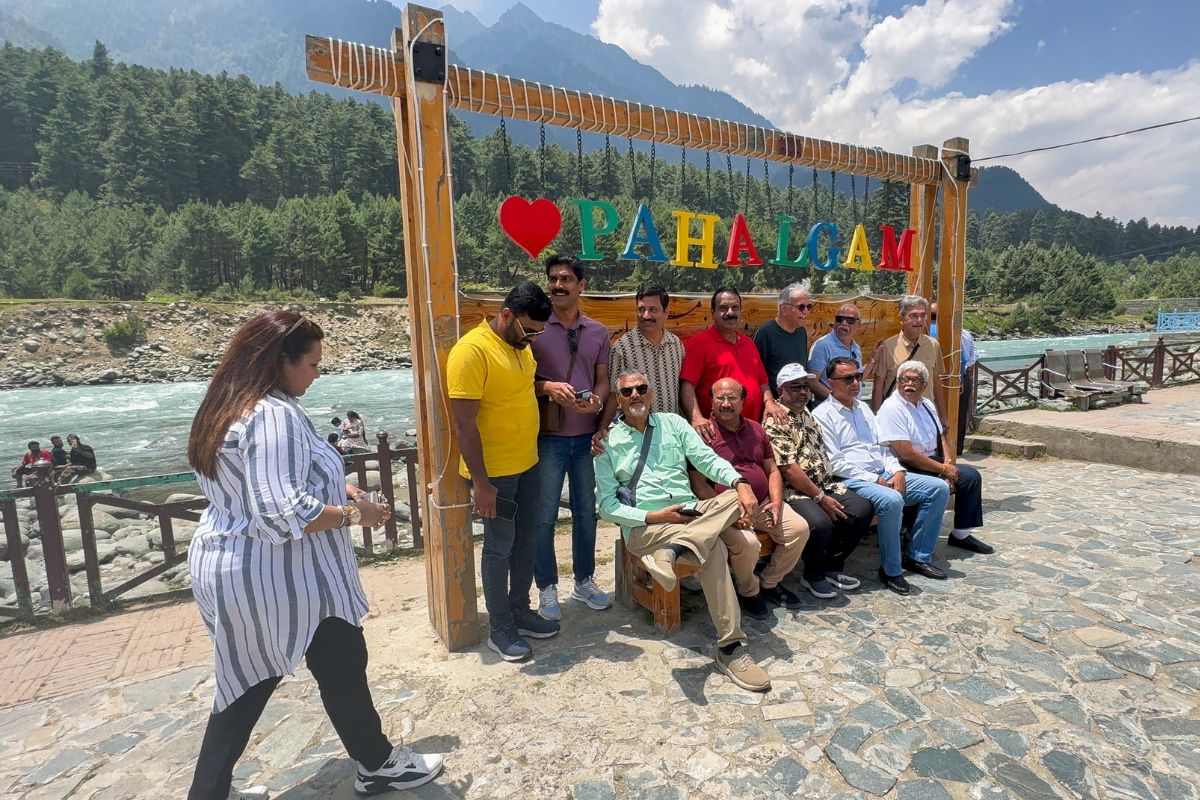 Tourists pose for a photograph