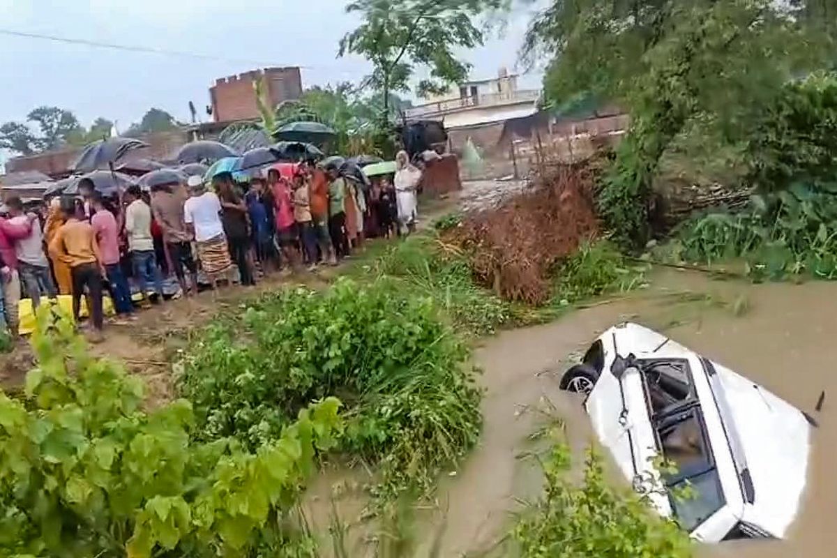 People stand near Saryu canal