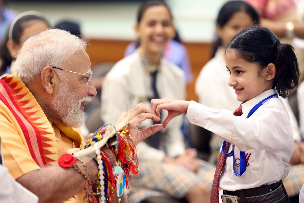 PM Modi and Defense Minister Rajnath Singh celebrating rakhi with children