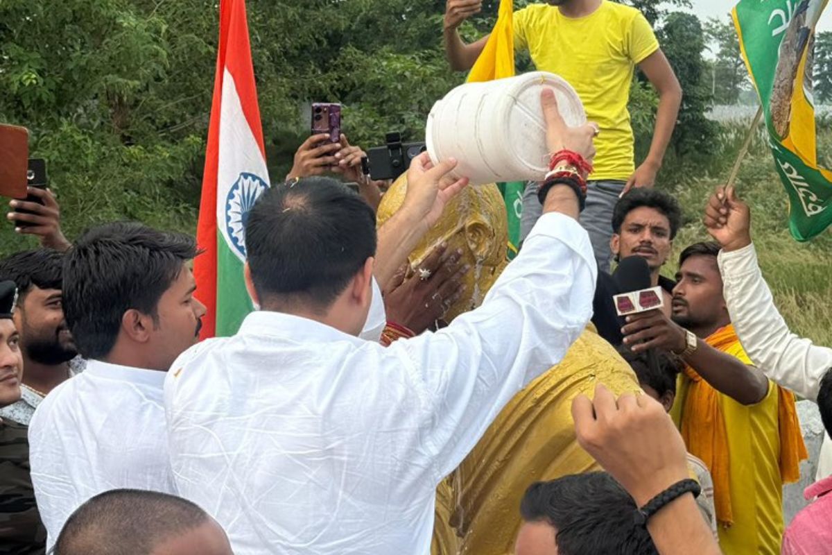 Tej pratap yadav cleans gandhi statue with Gangajal after bjp flagincident