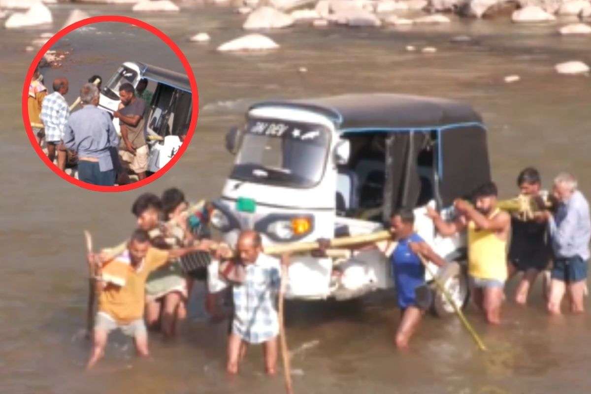 Villagers carry an Auto Rickshaw