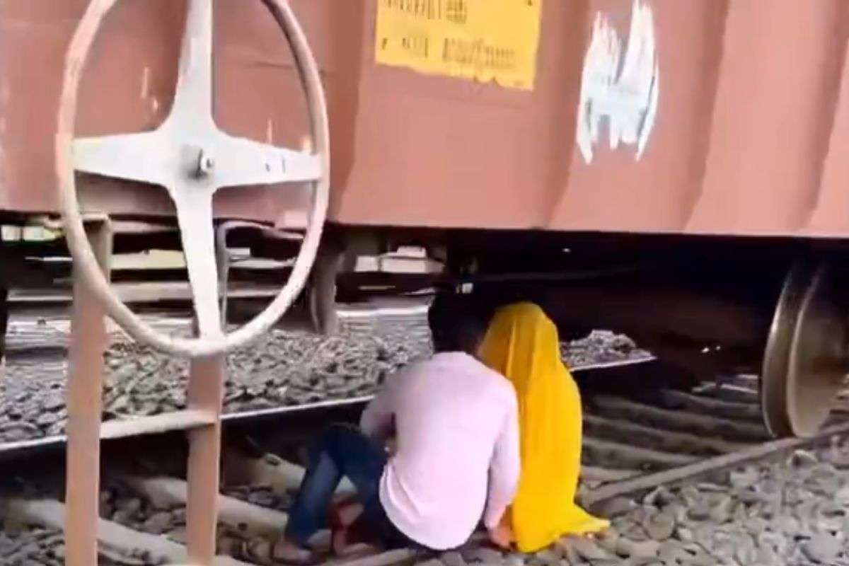 couple romancing under goods train